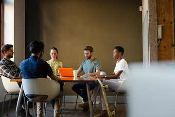 Casual business people meeting in circle in sunny office