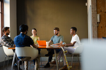 Casual business people meeting in circle in sunny office