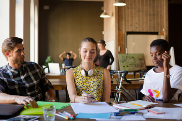 Casual business people discussing paperwork in office