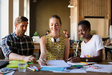 Casual business people discussing paperwork in office