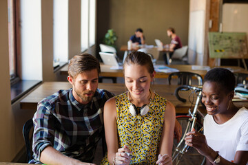 Casual business people discussing paperwork in office