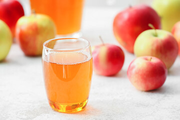 Glass of apple juice on table