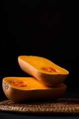 Butternut squash on black background, vegetable ingredient for healthy food in autumn and fall season