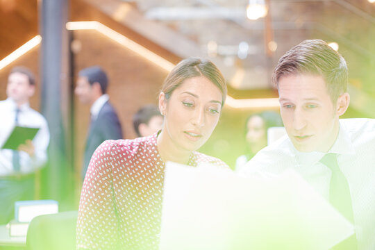 Business People Reviewing Paperwork In Office