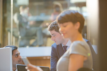 Businesswoman using cell phone in office
