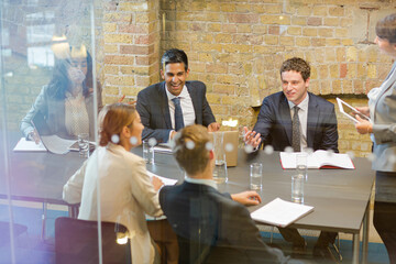 Businesswoman leading meeting in conference room