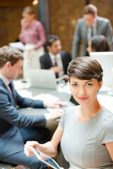 Smiling businesswoman holding tablet computer