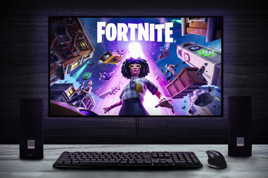 Cali, Colombia - August 15, 2021: Fortnite video game logo on PC screen with keyboard, mouse and speakers.