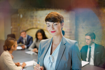 Portrait of confident businesswoman in conference room meeting