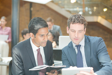 Businessmen using digital tablet in office