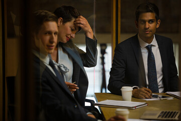 Business people talking at laptop in conference room