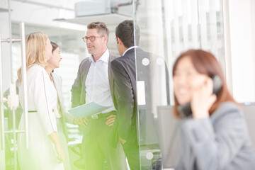 Smiling businesswoman talking on telephone in office