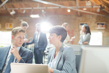 Business people working at laptop