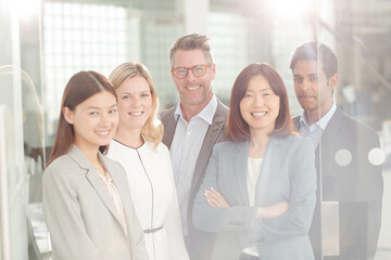 Portrait of confident business people in sunny office
