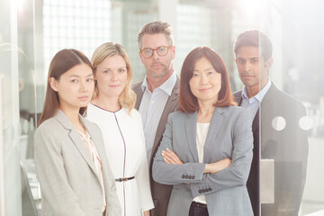 Portrait of confident business people in sunny office