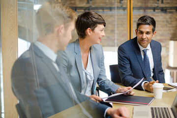 Business people talking at laptop in conference room