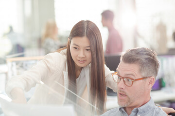 Fototapeta premium Fashion designers reviewing paperwork in office
