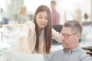 Fototapeta premium Fashion designers reviewing paperwork in office