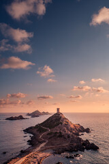 Sunset over the Genoese tower and lighthouse at Pointe de la Parata and Les Iles Sanguinaires near...