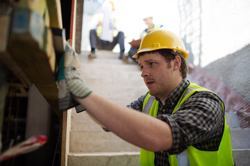 Fototapeta na wymiar Construction worker measuring window at construction site