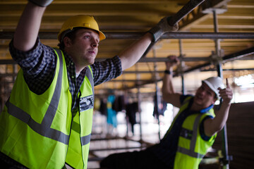 Constructor workers assembling rebar structure at construction site