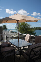 Outdoor patio dining table with waterfront view at a cottage