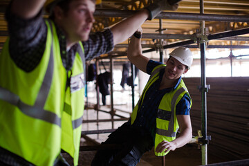 Constructor workers assembling rebar structure at construction site