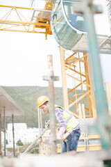 Constructor workers assembling rebar structure at construction site