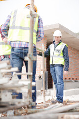 Constructor workers assembling rebar structure at construction site