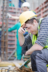 Construction worker with walkie-talkie at construction site