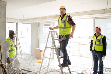 Construction worker on ladder at construction site © KOTO