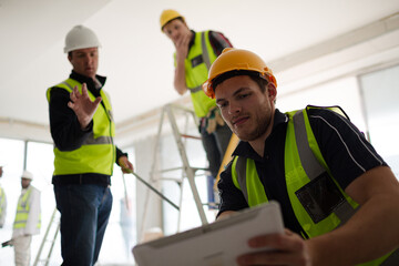 Construction worker with digital tablet at construction site
