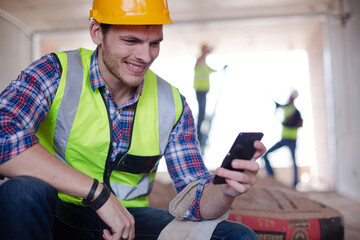 Construction workers using cell phone at construction site