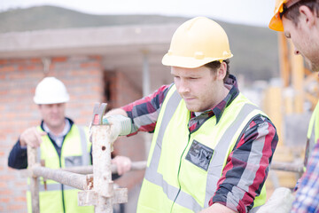 Constructor workers assembling rebar structure at construction site