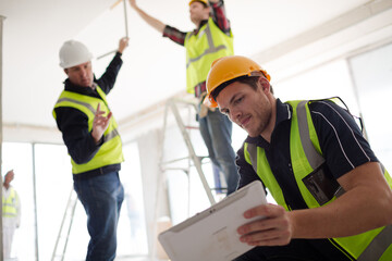 Construction worker with digital tablet at construction site