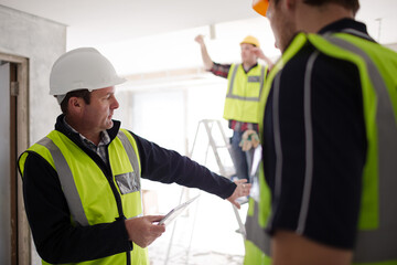 Foreman with digital tablet at construction site