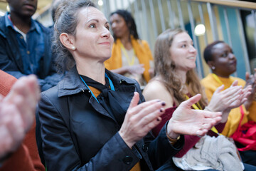 Smiling audience clapping