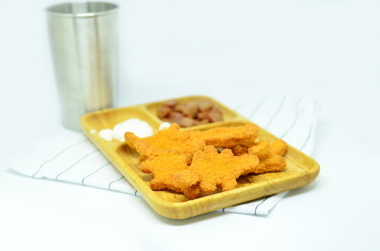 Chicken nuggets and sausage with mayonaise, studio shot with a white background