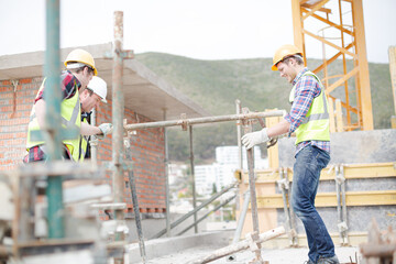 Constructor workers assembling rebar structure at construction site
