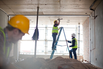 Construction worker on ladder at construction site