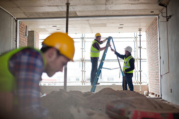 Construction worker on ladder at construction site