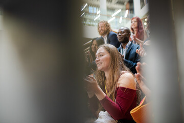 Enthusiastic audience clapping and cheering