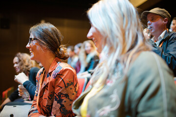 Businesswomen talking in conference audience