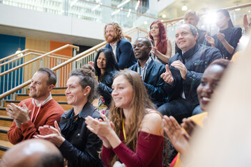 Enthusiastic audience clapping and cheering