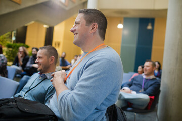 Fototapeta premium Smiling, attentive man in audience