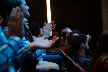 Smiling audience clapping