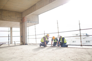 Construction workers working at highrise construction site