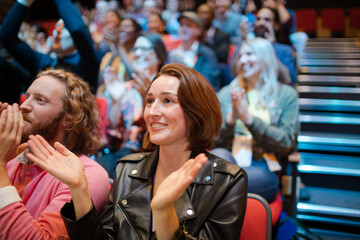 Smiling, excited audience cheering