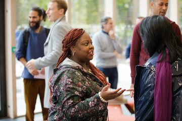 Two women greeting in hallway