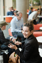 Woman applying make up in hall of auditorium